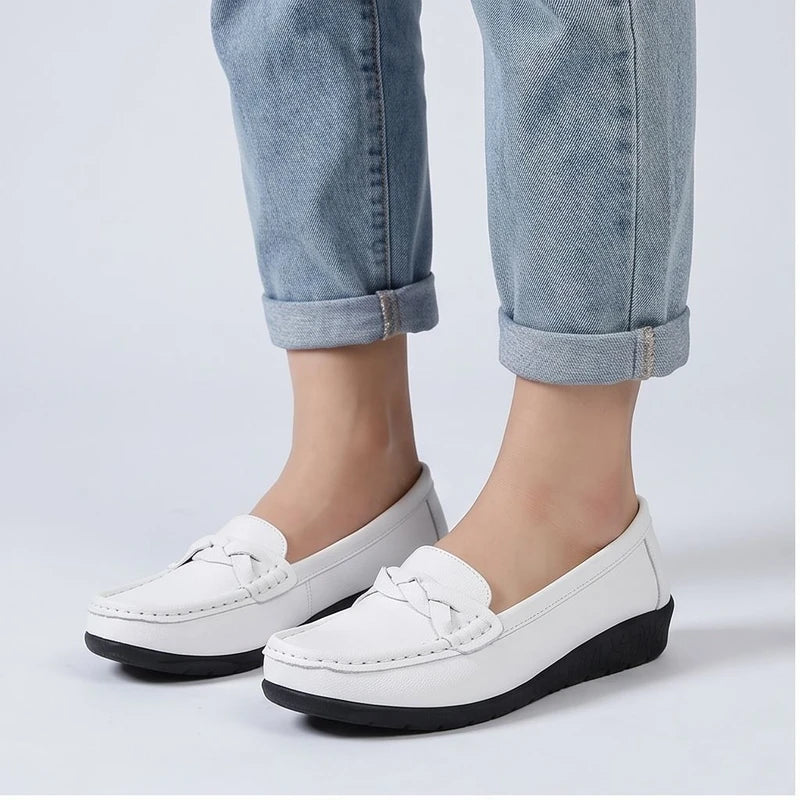 Model wearing White leather flats in a studio