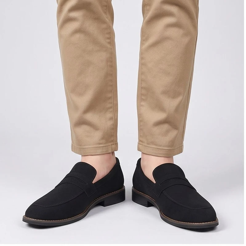 Model wearing Black suede loafers in a studio