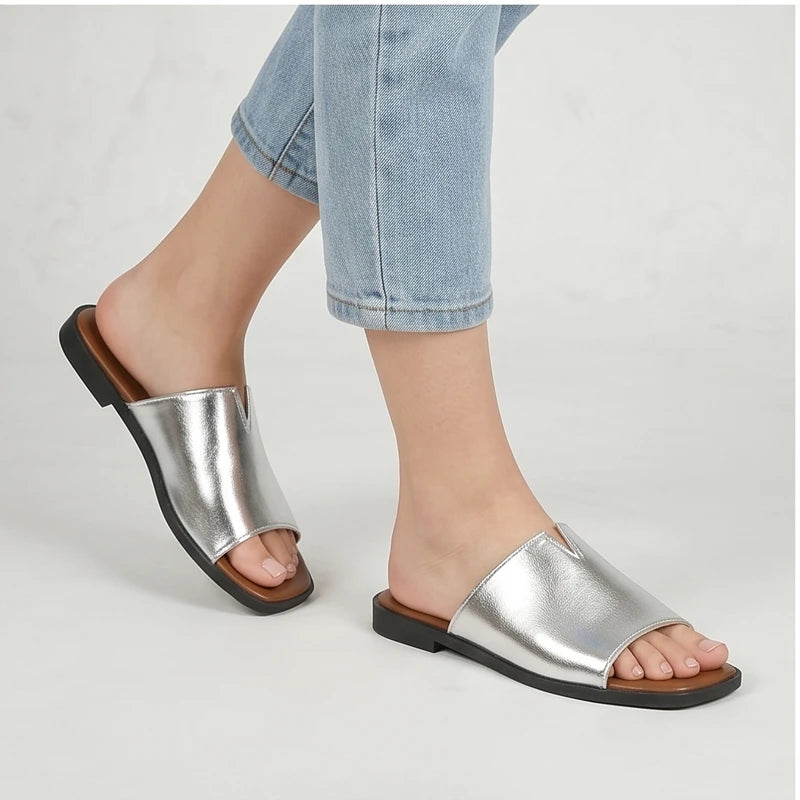 Model wearing Silver Shiny Metallic Flat Slides for Women Square Toe Open Toe Lightweight Comfortable Summer Beach Casual Daily Walking Shoes in studio - 3