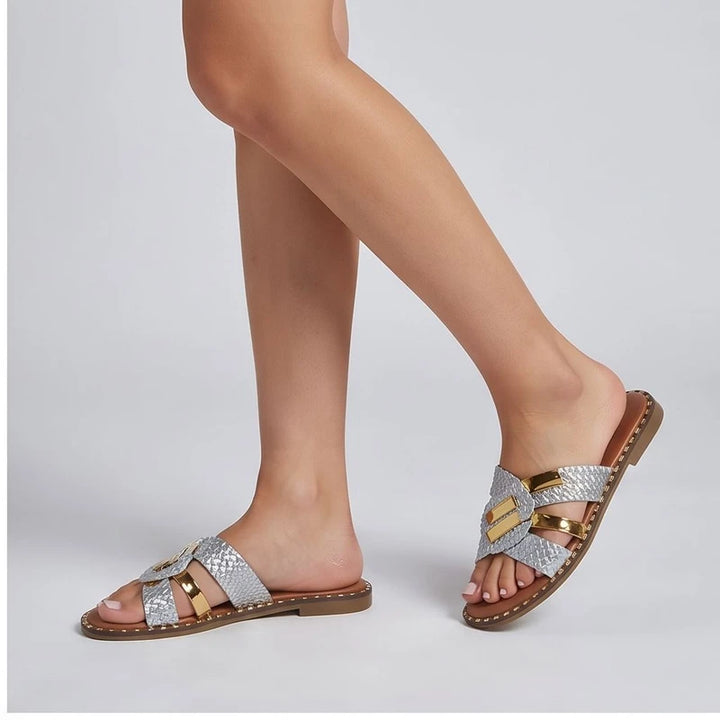 Model wearing Silver slippers in a studio