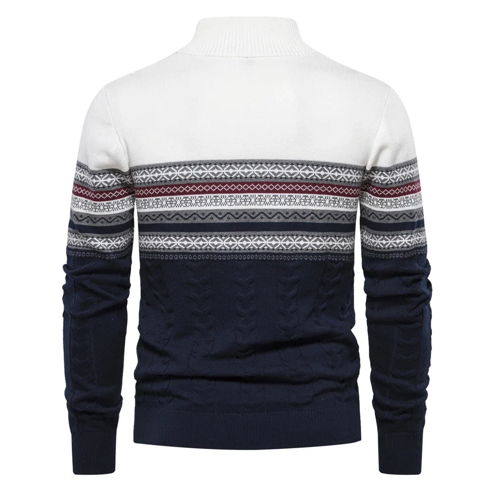 White and navy sweater with patterned sleeves on a white background