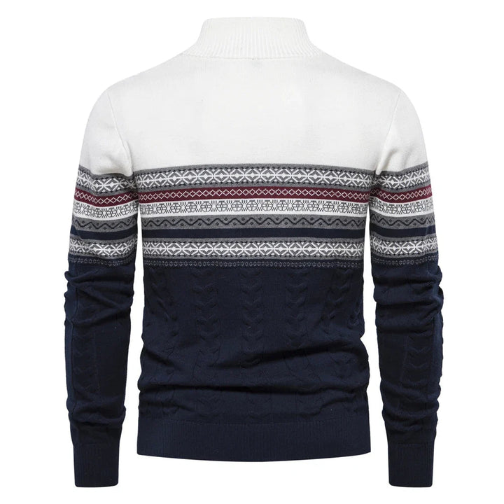 White and navy sweater with patterned sleeves on a white background