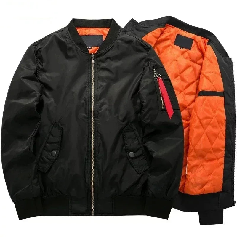 Black bomber jacket with a shiny finish and ribbed trim, showing its vibrant orange quilted lining and sleeve pocket with red tag.
