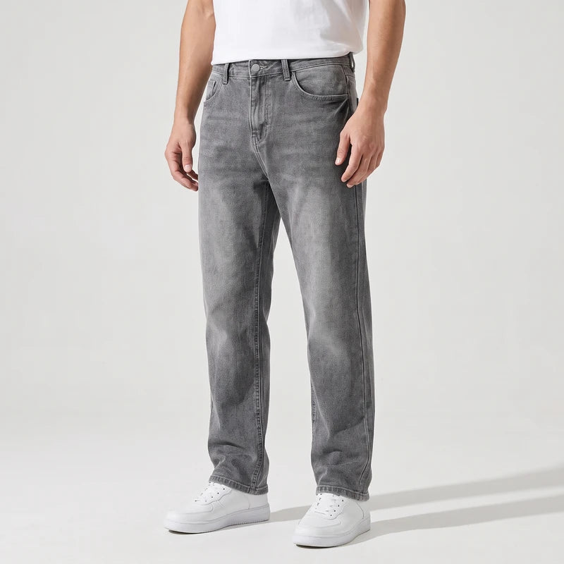 Grijs jeans on an off-gray studio background