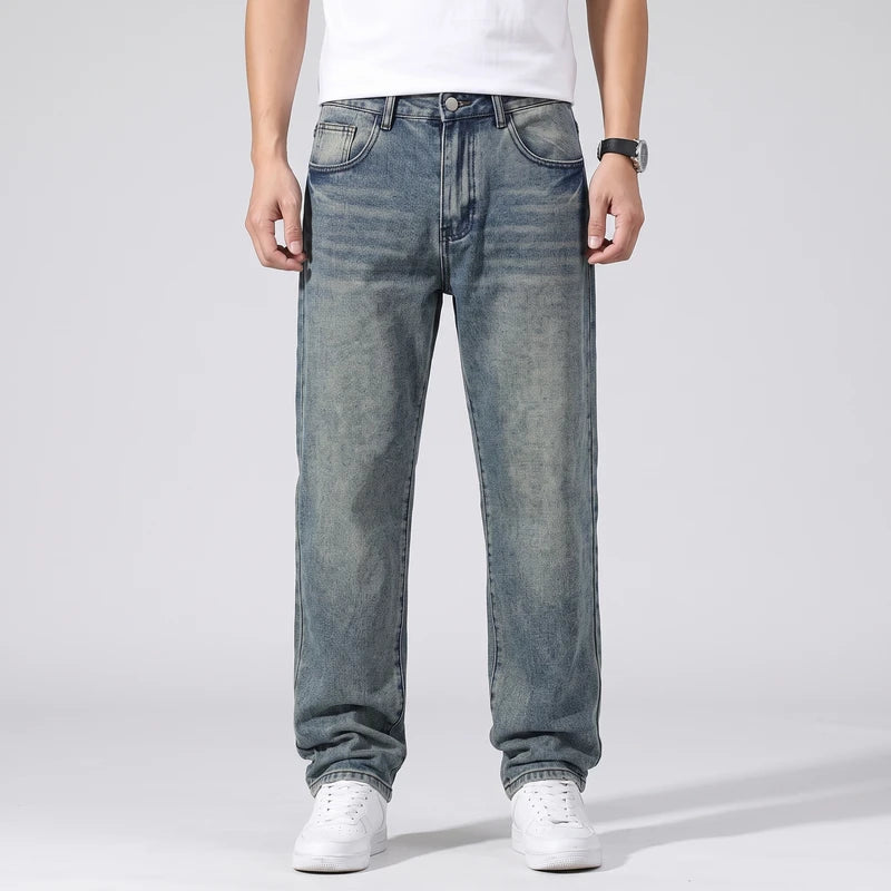 Petrol jeans on an off-gray studio background