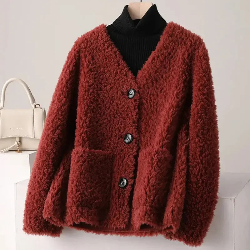Red fluffy cardigan on a mannequin with a white background