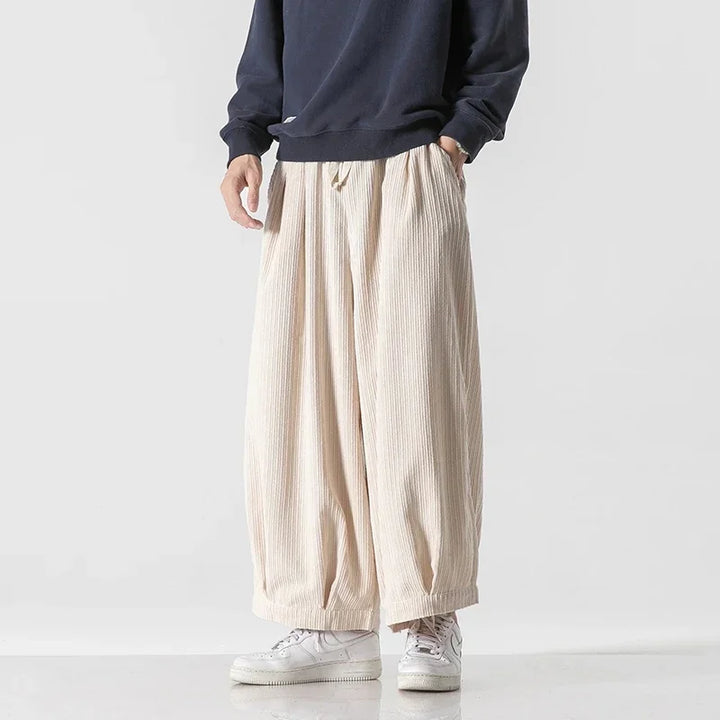 Vera corduroy pants featuring a relaxed silhouette, deep pleats, and an elastic waistband for comfort and style.