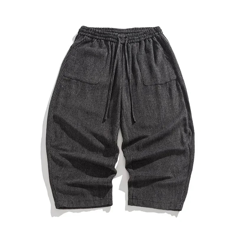 Henderson wide-leg corduroy pants in dark gray with gathered elastic waistband and deep pleats for a relaxed fit.