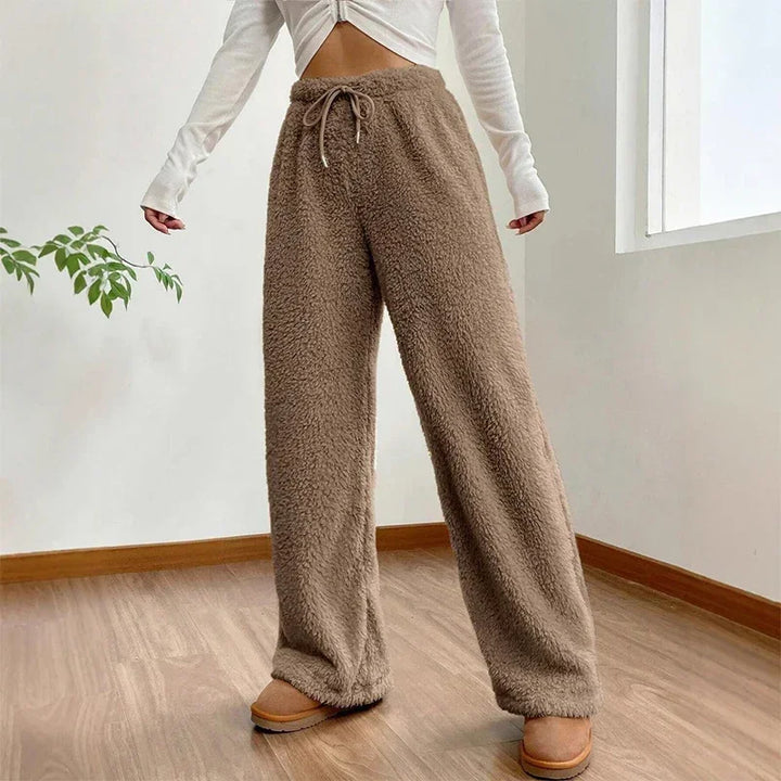 Soft brown Sherpa flow sweatpants with a relaxed wide-leg fit and adjustable drawstring waist, perfect for lounging.