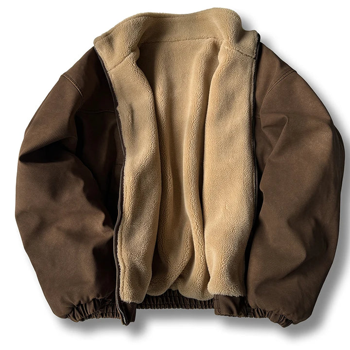 A brown zip-up jacket laid flat on a white background, featuring a plush beige sherpa fleece lining and elastic hem.