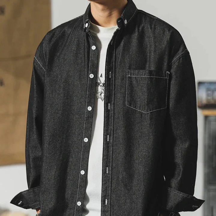 Frontier Denim Jacket showcasing a stylish minimal design and subtle distressing in dark denim fabric.