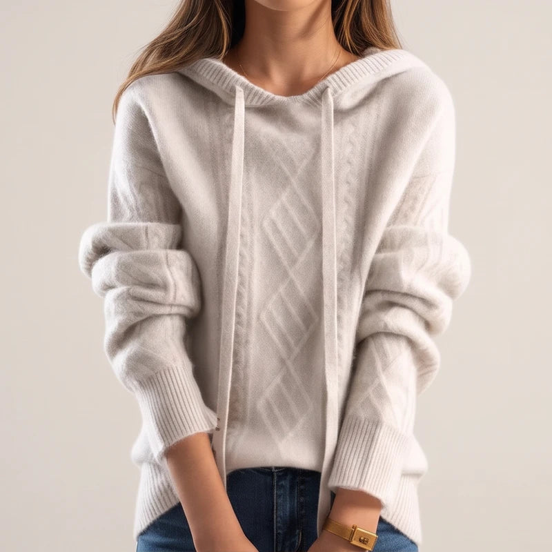 Model wearing cream knit sweater in a studio