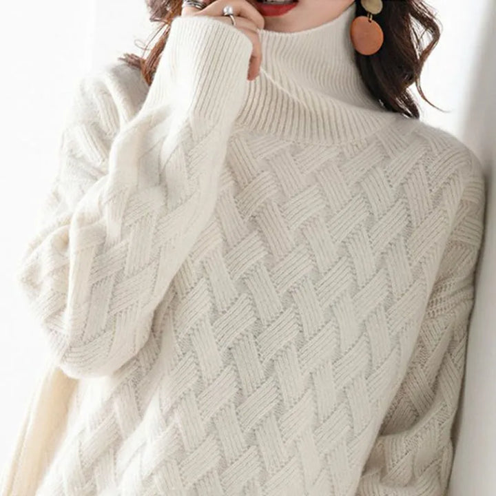 Close-up of a person wearing a white turtleneck sweater with a textured pattern.
