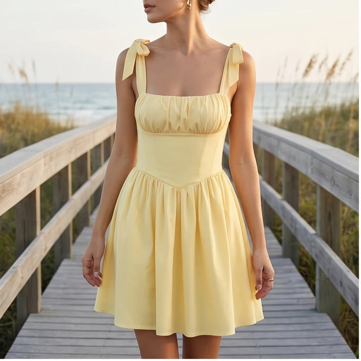 Model wearing S Solara Tie-Strap Yellow Mini Dress outdoors