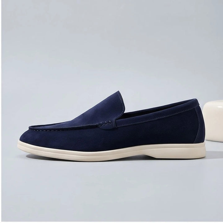 dark blue suede loafers in a studio background - 2