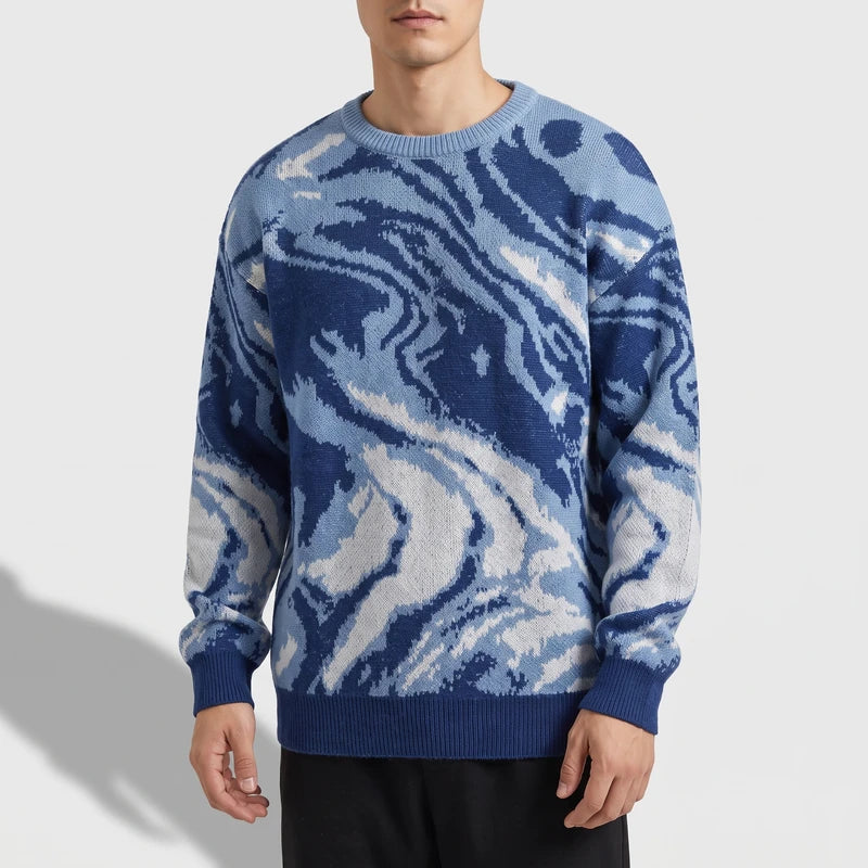 Blue knitted pullover on an off-gray studio background