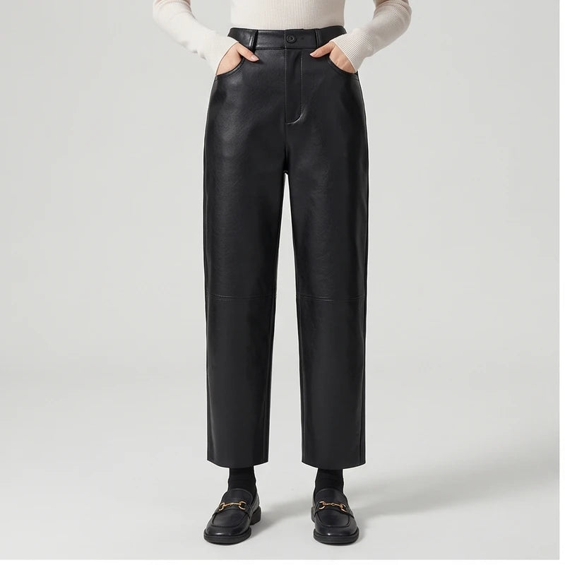Black leather pants on an off-gray studio background