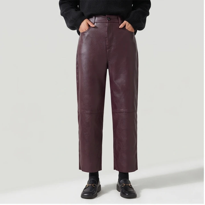 Burgundy leather pants on an off-gray studio background
