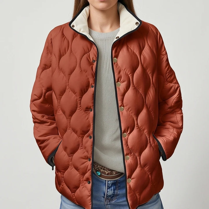Orange cotton jackets on an off-gray studio background