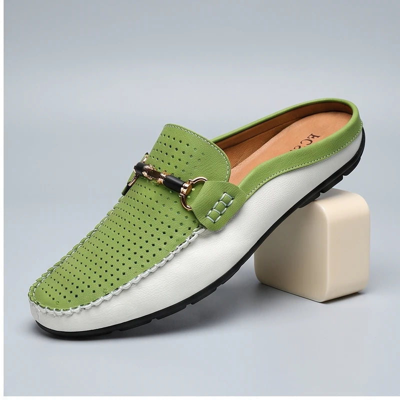 Green leather loafers in a studio background