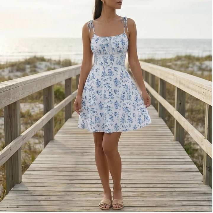 Model wearing Blue Evelyn Floral Mini Dress outdoors