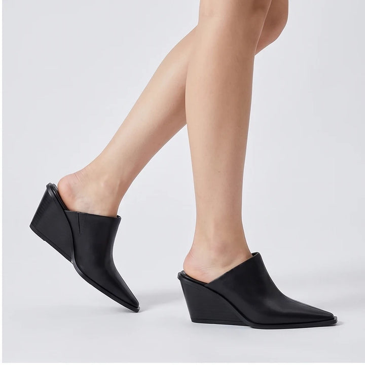 Model wearing black cowhide Valdis Genuine Leather Wedge Mules in studio - 2