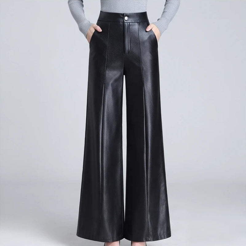 Black leather pants on an off-gray studio background