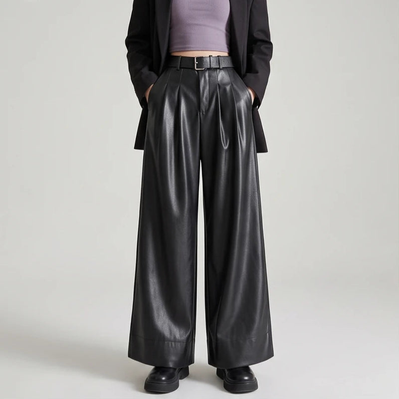 Black leather pants on an off-gray studio background
