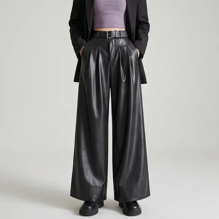 Black leather pants on an off-gray studio background