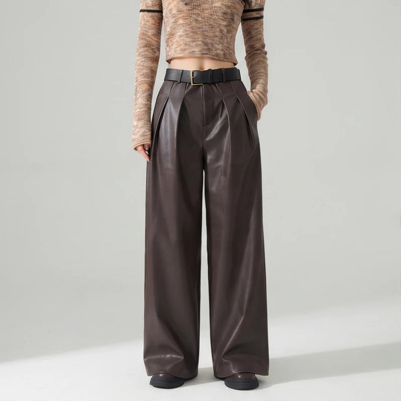 Coffee leather pants on an off-gray studio background