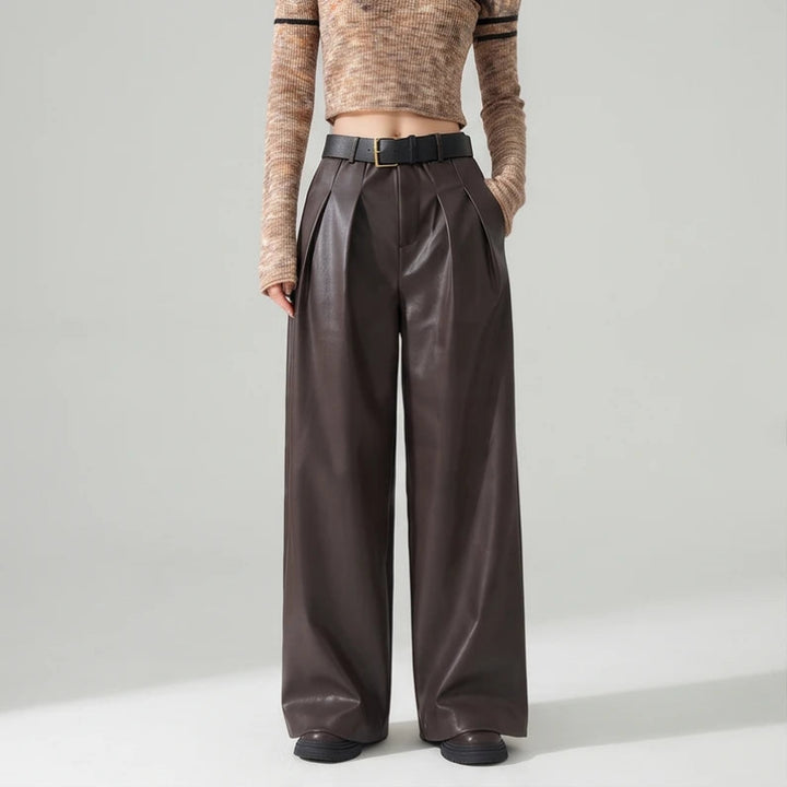 Coffee leather pants on an off-gray studio background