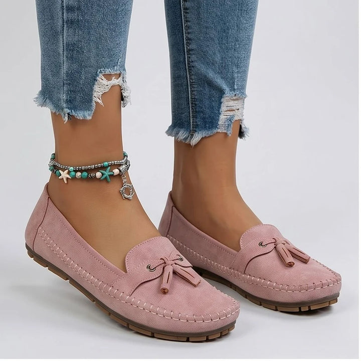 Model wearing Pink loafers in a studio