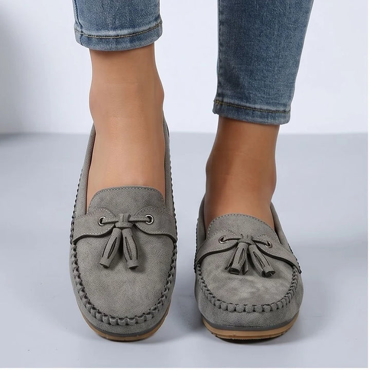 Model wearing Gray loafers in a studio