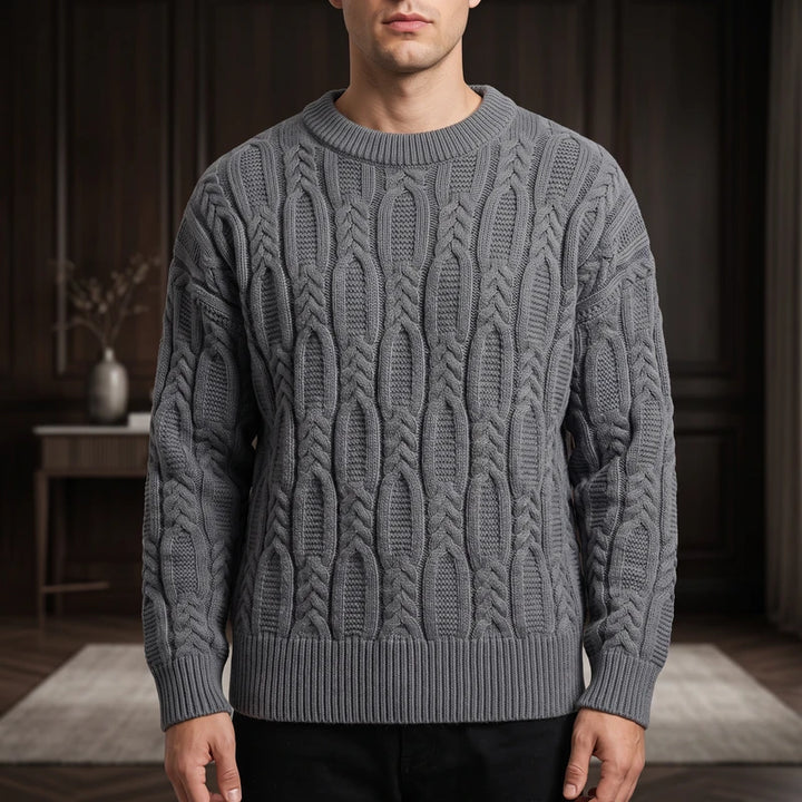 Gray knit pullover in a dark wood interior