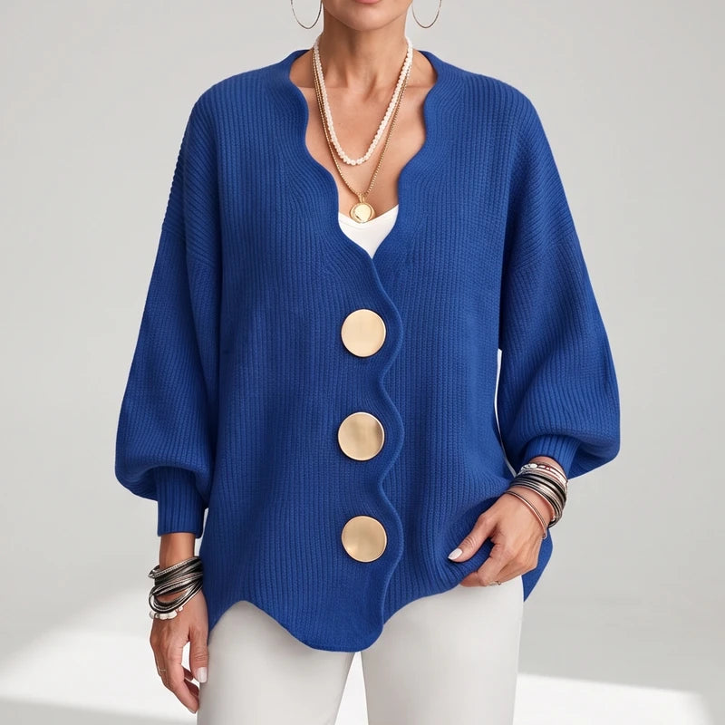 Blue knit sweater on an off-gray studio background