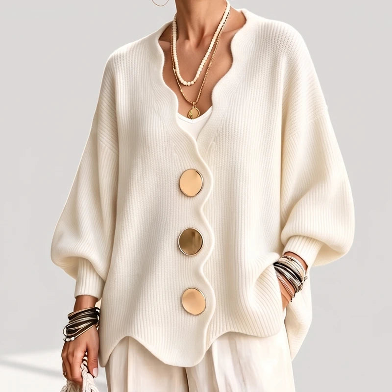 creamy-white knit sweater on an off-gray studio background