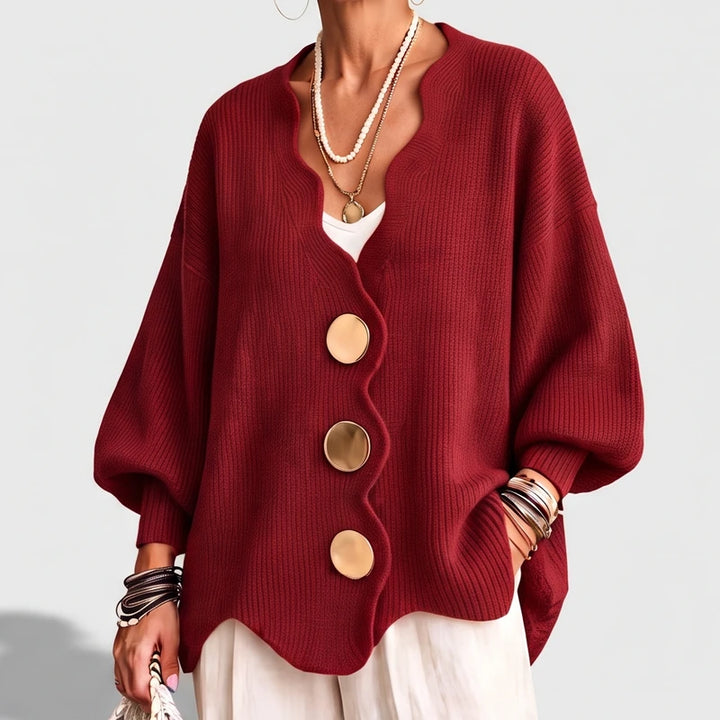 Red knit sweater on an off-gray studio background