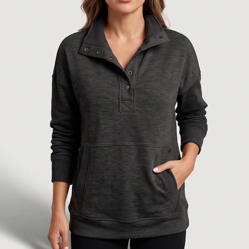 black pullover on an off-gray studio background