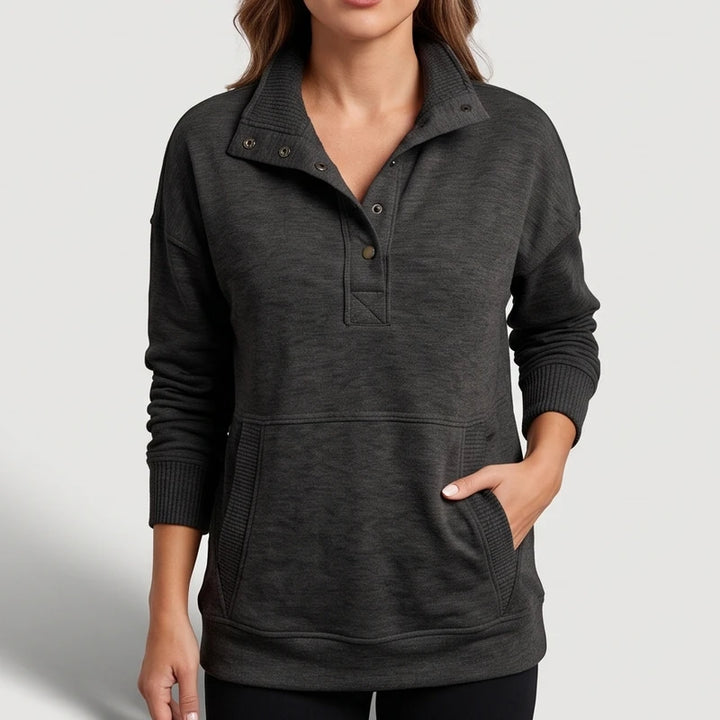 black pullover on an off-gray studio background