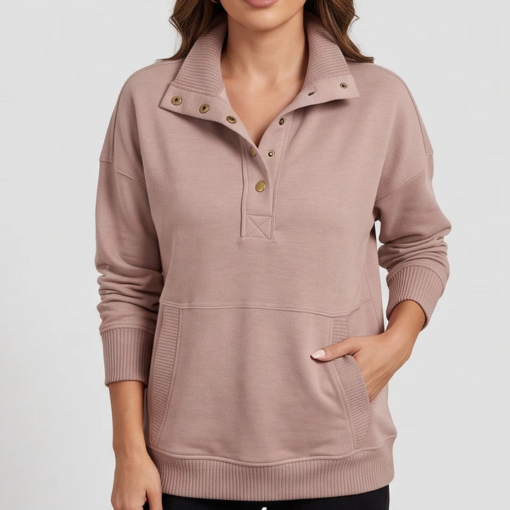 Peach pullover on an off-gray studio background