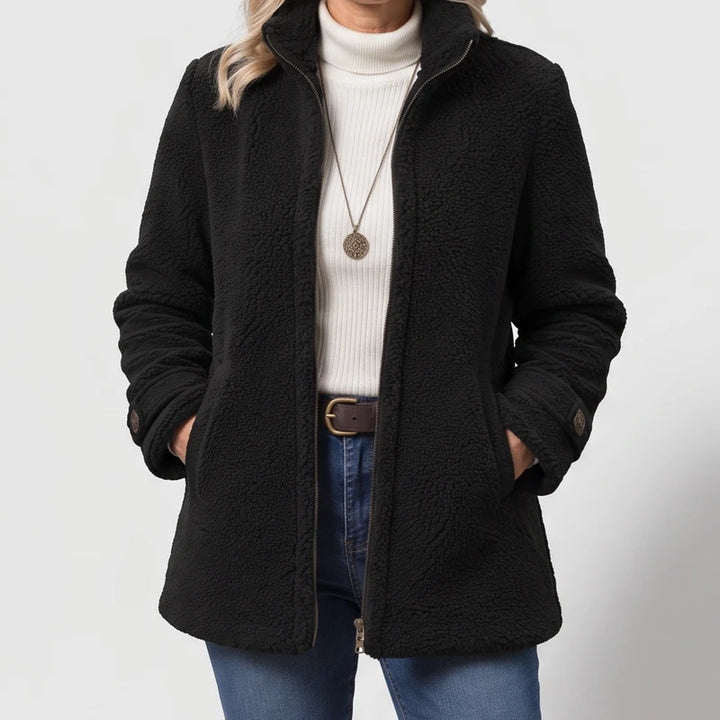 Black jacket on an off-gray studio background