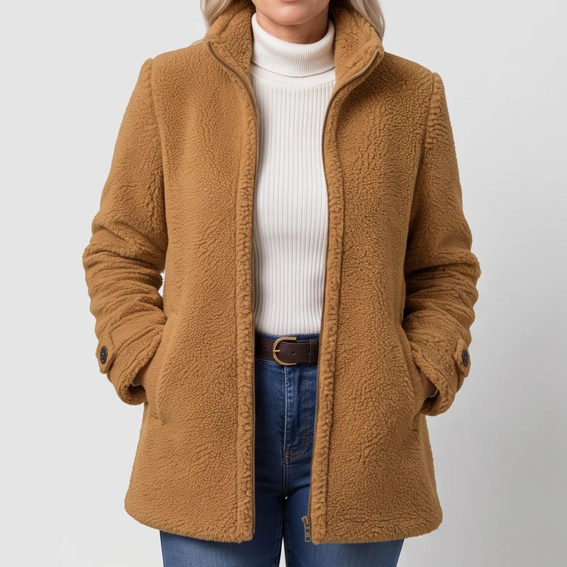 Camel jacket on an off-gray studio background