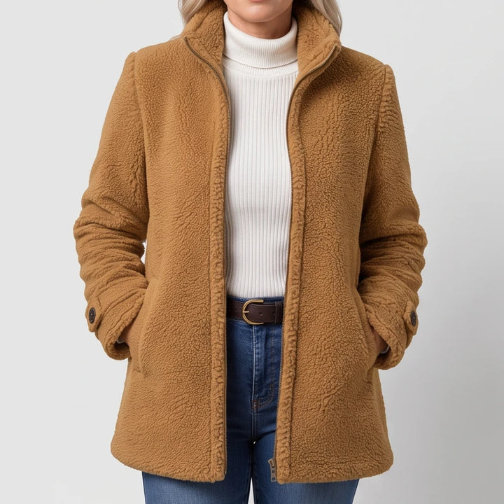 Camel jacket on an off-gray studio background