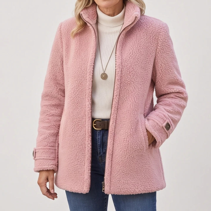 Pink jacket on an off-gray studio background