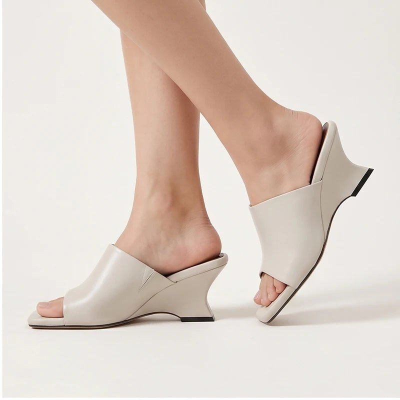 Model wearing White Olympia Genuine Cowhide Leather Heeled Mules in studio - 2