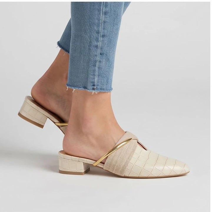 Model wearing Ivory Cream mules in a studio - 2