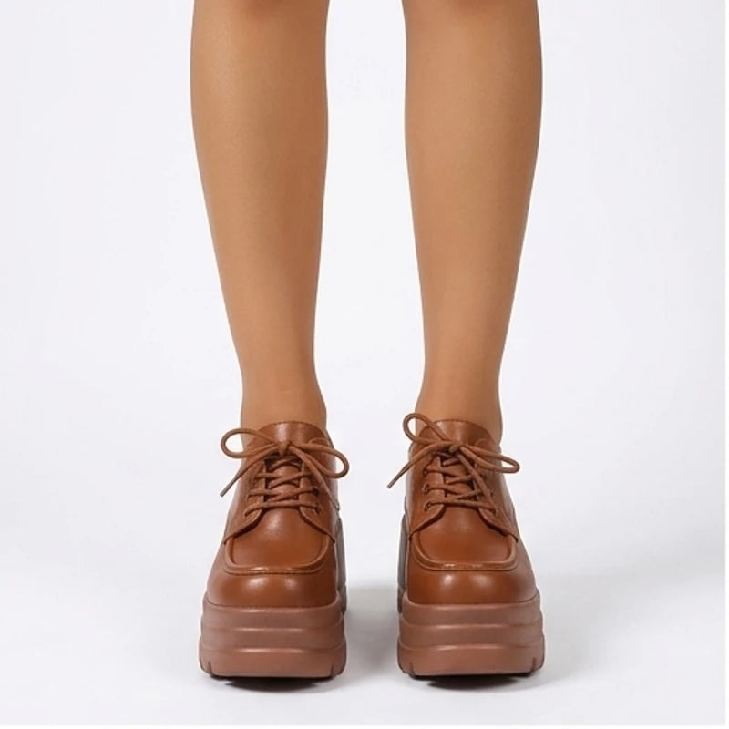 Model wearing Brown Veya Chunky Platform Leather Boots in studio
