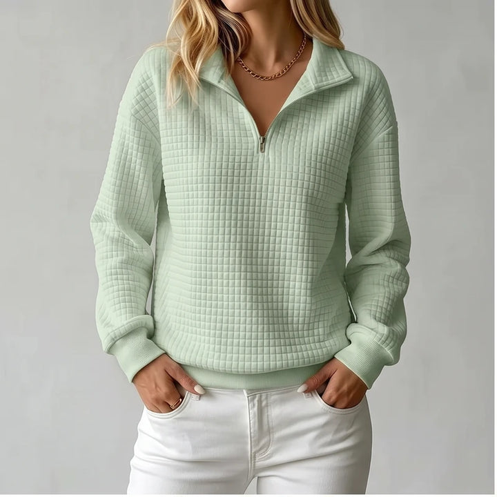 Model wearing Green knit pullover in a studio