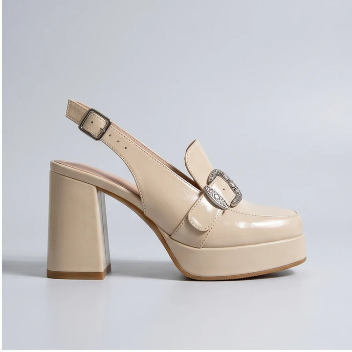 Cream leather slingback platform heels with a decorative buckle and block heel.