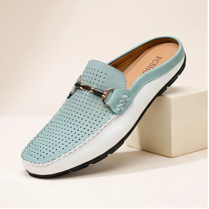 Blue leather loafers in a studio background